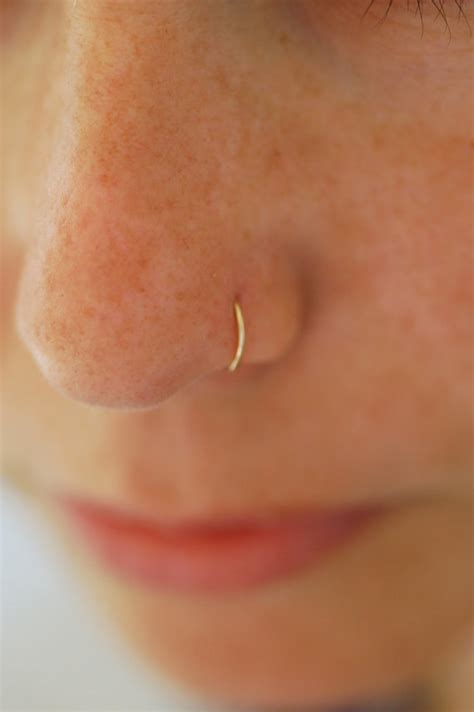 Certain working environments don't allow face or ear piercings. Small gold nose hoop 22 GAUGE gold nose ring 14k gold nose