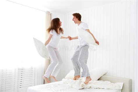 You our beautiful family and my husband love to travel and have fun in the sun! Happy Couple Jumping And Having Fun In Bed Stock Photo ...