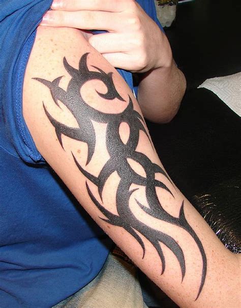 This simple tribal tattoo design also has a pair of wings along the side. Best Tribal Arm Tattoo Designs for Men - The Xerxes