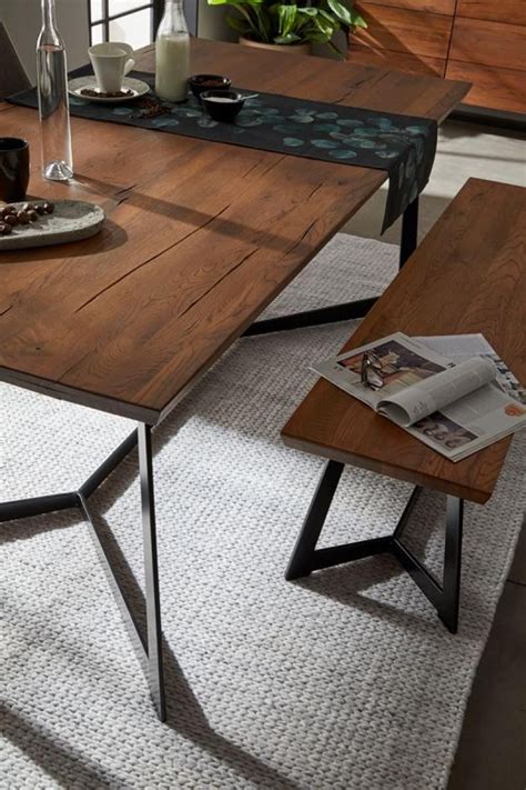The iron legs are in a black finish, and the legs are in a trapezoid shape, adding a contemporary touch to the bench's. Modern dining table in solid Oak with black metal base ...