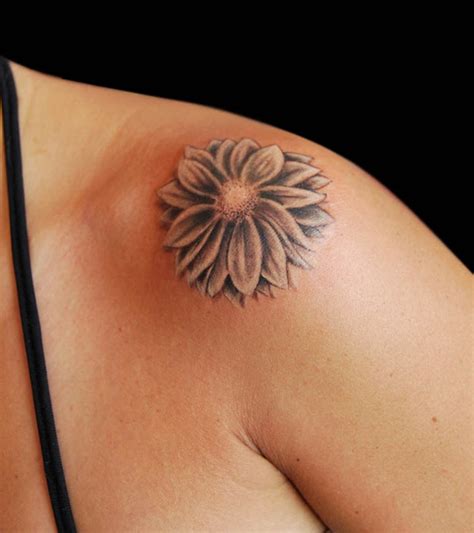 A simple pink flower tattoo that is wonderfully original. Colorful blowing daisy flower tattoo for you - Body Tattoo Art