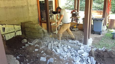 Building codes require grout filling, rebar, and a gravel or concrete foundation according to the wall type and location. Jesse Tearing Down a Cinder Block Wall With a Sledge - YouTube