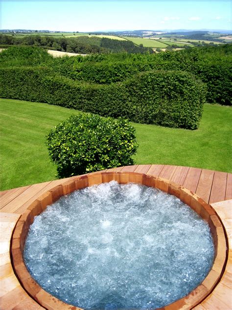 The truth is that it would be inaccurate to choose between the two. Wooden Barrel Hot Tub Installers | Hot tub landscaping ...