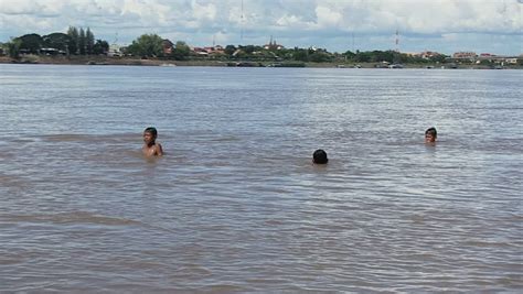 At beaches, swimming pools and sunbathing areas; Cambodia - November 2013. Boys Playing In The River Stock ...