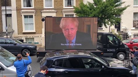 Dominic cummings arrives at his north london home. Protesters send van with 'stay at home' message to Dominic ...