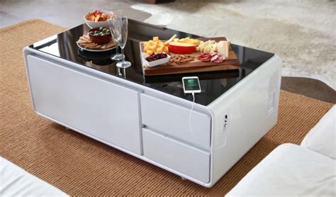 This piece is a coffee table by day, but at night, its top can be raised ten inches to create a standing bar table, while its base transforms into a party cooler! Epic Coffee Table That Chills Beer, Charges Phones, Plays ...