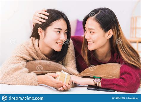 One person watches tv with no signal and grainy noise effect in his bed with his feet bellow of the sheets. Young Beautiful Asian Women Lesbian Couple Lover Giving ...