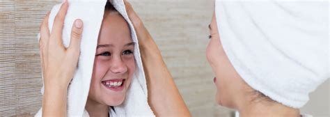 It cuts my hair drying time in half. mother towel drying daughters hair cropped - Bathtime Mobility