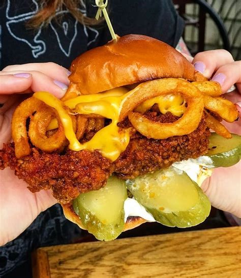 Spread mayonnaise on bottom halves of. Nashville hot Fried Chicken Sandwich stacked with curly ...