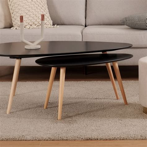 The iconic ellipse of the coffee bean table is supported by low tubular legs in natural metal. Bean Coffee Table Black - Ruma