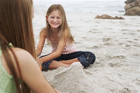 Caucasian baby boy plays with trumpet between sheets with musical notes against brown background. Girl Making Sand Castle With Sister At Beach Stock Photo ...