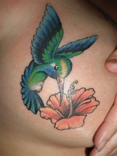 The hummingbird can serve as a centerpiece amongst the floral. Gree Hummingbird and Flower Tattoo Designs