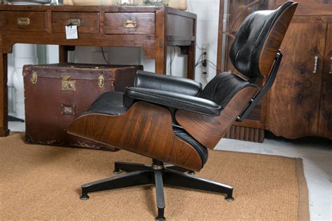 Black leather swivels and tilts. Vintage Eames Lounge Chair and Ottoman at 1stdibs