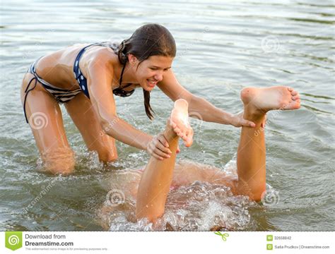 Girls having fun with sprinkler in garden. Teenage Girls Playing In The Water Stock Photography ...