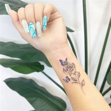 It will be the most stunning wrap for your feet with the floral designs around splitting butterflies is one such tattoo which spreads out on your back shoulder. Rose&Butterflies Tattoo🌹💙🦋 in 2020 | Rose and butterfly ...