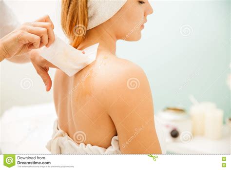 Depilatory creams work by breaking down the keratins (proteins) in hair, which in turn releases the hair from the follicle and skin. Removing Hair From The Back Of A Woman Stock Image - Image ...