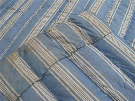The term 'topper' refers to an individual cushioning layer that can be added to a. primitive old feather tick bed or duvet, vintage blue ...