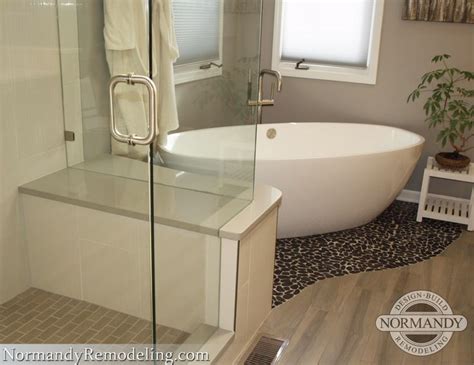 Bathtub tile ideas and design. Check out the pebble floor under the freestanding bathtub ...