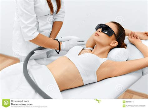 Woman showing armpit on the blue background. Body Care. Laser Hair Removal. Epilation Treatment. Smooth ...