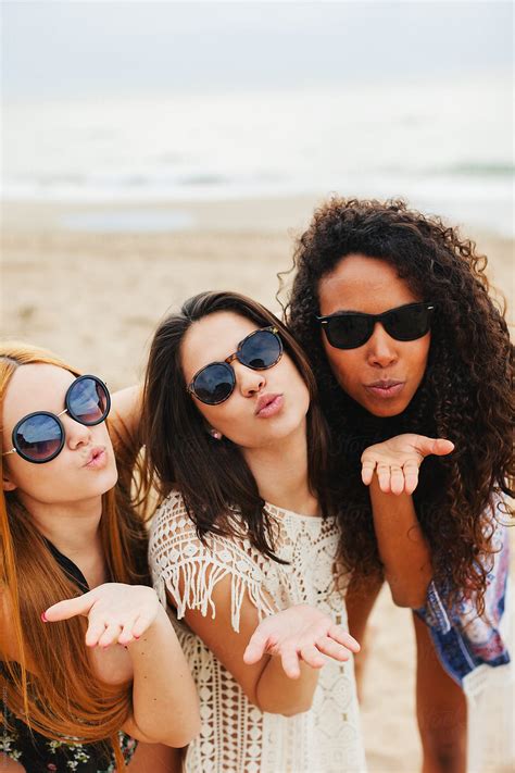 "Portrait Of Female Friends Having Fun On The Beach." by Stocksy