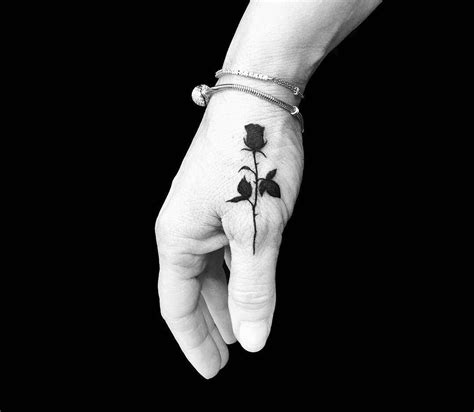 How long do finger tattoos last faded and blurred fingers. Black rose tattoo by Roy Tsour | Photo 26031