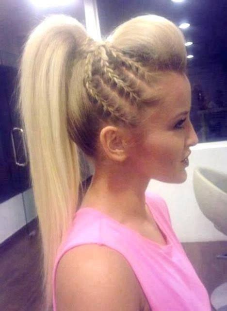 A sultry hairstyle like this can be achieved by using the fishtail braiding technique on each side, then pulling everything into an untidy ponytail. Glamorous rockstar hairstyles! | Long hair styles, Cheer hair