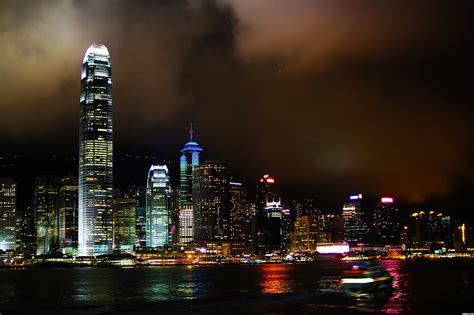 Hong kong city skyline timelapse at night with victoria harbor and skyscrapers illuminated by lights over water viewed from mountain top. Hong Kong, City of Lights picture, by TankRed for ...