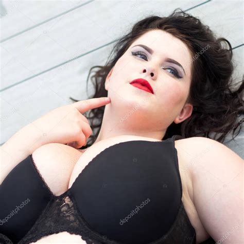 Use them in commercial designs under lifetime, perpetual & worldwide rights. Young beautiful plus size model lying on the wooden ...