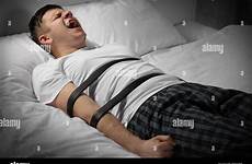 tied man bed young alamy stock belts photography