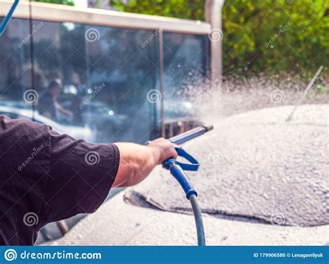 You will find an unattended terminal where you buy a car wash service. Man Washing Car With Foam And Hose At A Do It Yourself Car Wash Stock Photo - Image of hose ...