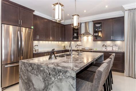 These counters drop vertically down the sides instead of stopping abruptly at the edge of a cabinet or island, creating a continuous flow that links the floor to the cabinetry in a fluid design. Beautiful Waterfall Kitchen Islands (Countertop Designs ...