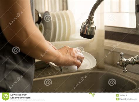 Never microwave a dry sponge as it could catch fire. Woman Hands With Sponge Washing Dishes Stock Photo - Image ...