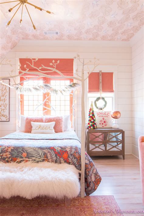 Young beautiful woman in blue pajamas sitting on bed resting happy and positive smiling enjoying weekend in bedroom interior. A Little Christmas Decor in Addison's Coral Girl's Bedroom ...