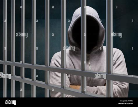 Digital composite of Anonymous Criminal in hood behind ...