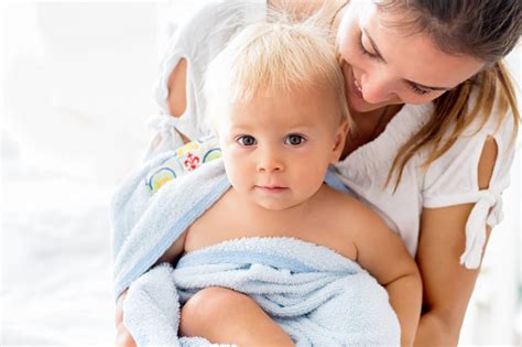 Never leave your baby alone in the water. Young Mom Playing With Her Toddler Baby Boy After Bath ...