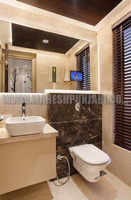 Sand colour scheme with mosaic tiled wall toilet design. Interactive TV built inside mirror | Bathroom design ...