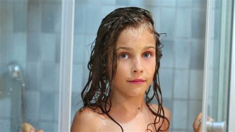 All models were 18 years of age or older at the time of depiction. Stock video of little girl closes shower unit door ...