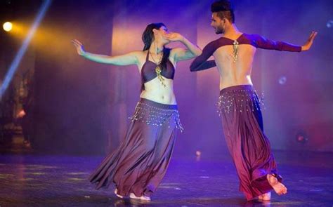 Shot in a dark studio with smoke and red neon lighting. This male belly dancer is demanding just one thing from ...