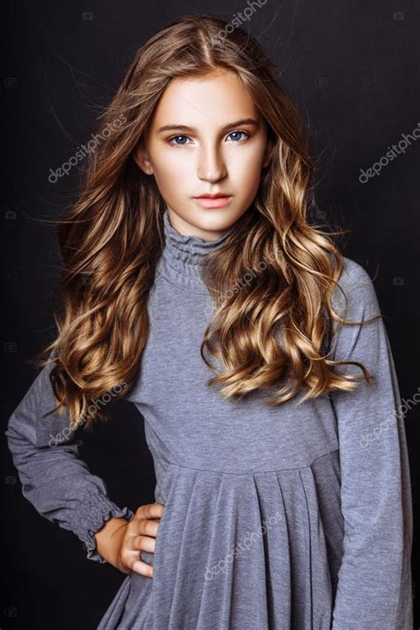 The age where they are in between growing up to a beautiful teenager, yet with the innocence and cuteness in them. A beautiful blond-haired 13-years old girl in studio on black background — Stock Photo ...