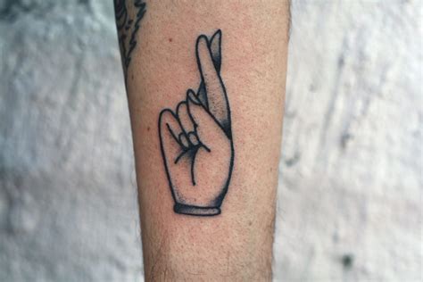 Here is a ganesha tattoo on the finger of this boy. 11 Offbeat Fingers Crossed Tattoos | Tattoodo