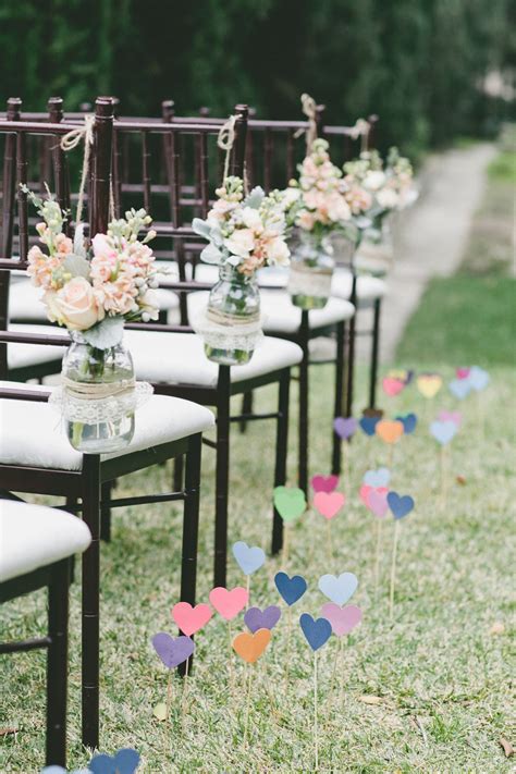 Decorate the ceremony chairs for a whole new look with satin and organza ribbon. Wedding ceremony chair decorations diy mason jars