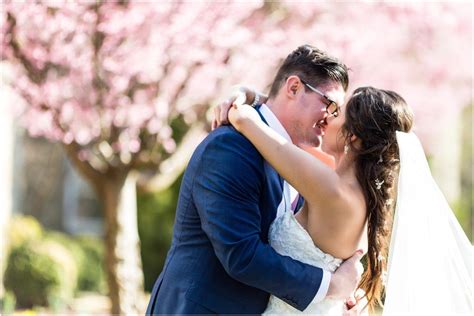 This pink floral lace wedding dress with textured skirt from stella york is a masterpiece! Bride in Pronovias dress sharing a kiss with her new ...