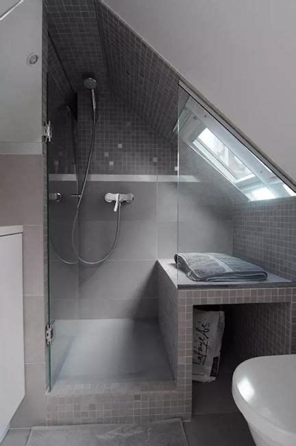 Gorgeous attic bathroom with sloped ceiling, blue walls paint color, frameless glass shower with subway tiles shower surround, black stool and white bath mat. Interior Design Ideas, Beautiful and Functional Small Spaces with Inclined Walls | Small attic ...