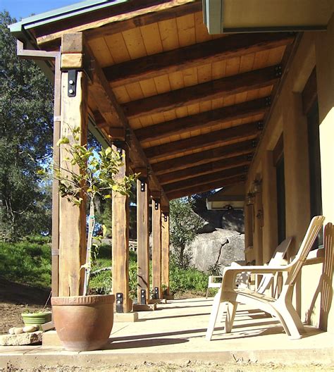 Straw bale construction lends itself well to an owner builder project. big, reclaimed posts and beams frame the porch on this ...