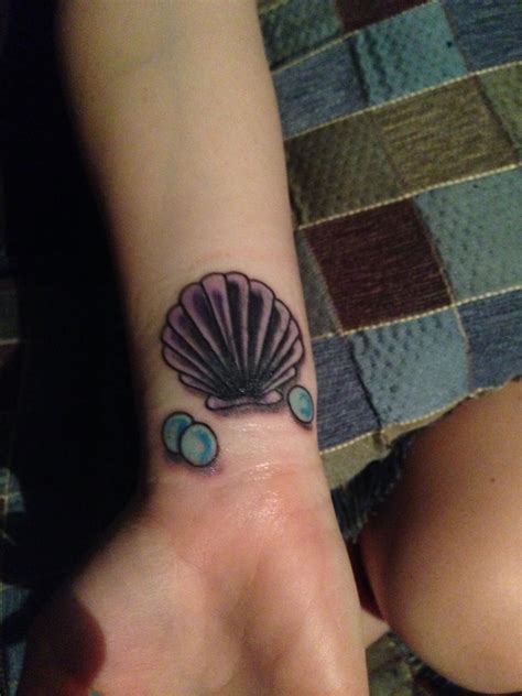 This minimal wrist tattoo design represents your love for the sea while symbolizing happiness, freedom, protection, and prosperity. Seashell tattoo | Tattoos, Seashell tattoos, Tattoos and ...