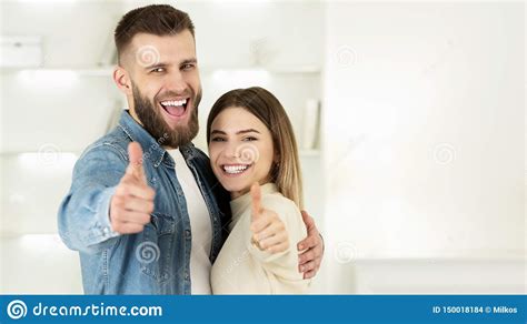 Couple Recommending Real Estate Agency, Showing Thumbs Up Stock Photo - Image of indoor, showing ...