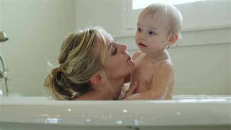 Adorable baby taking bath in blue tub. Mother And Baby Taking A Bath Stock Footage Video 11720864 ...