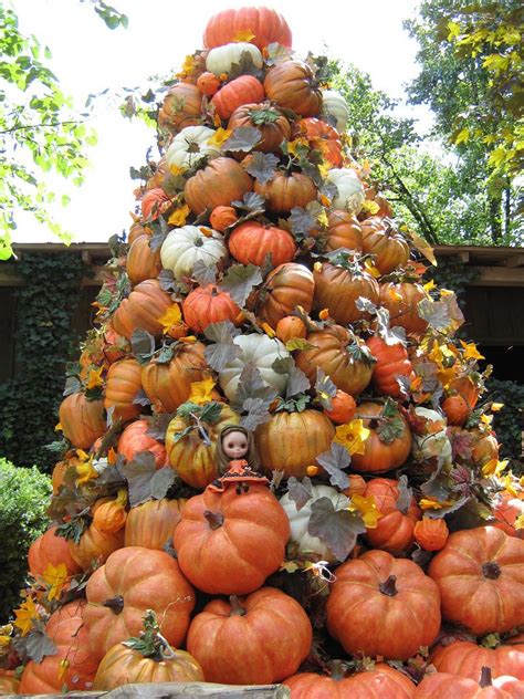 The artificial pumpkin tower décor features three pumpkin gourds sitting atop an earthen pot. Pumpkin Tower at Dollywood | Halloween outdoor decorations ...