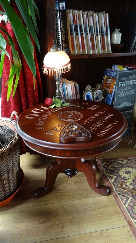 The wooden coffee table features a glass fixture and wheels, of course. Ouija Board SIDE TABLE & Planchette Large Ouija Board ...