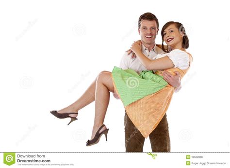 Bavarian Man Carries Woman With Dirndl On Hands Stock Photo - Image: 19622088